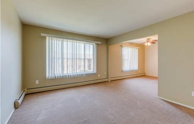 the living room of an empty house with large windows