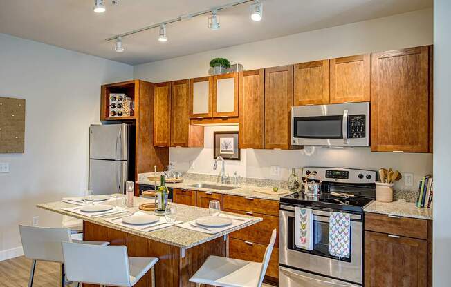 A kitchen with wooden cabinets and a stove top oven.