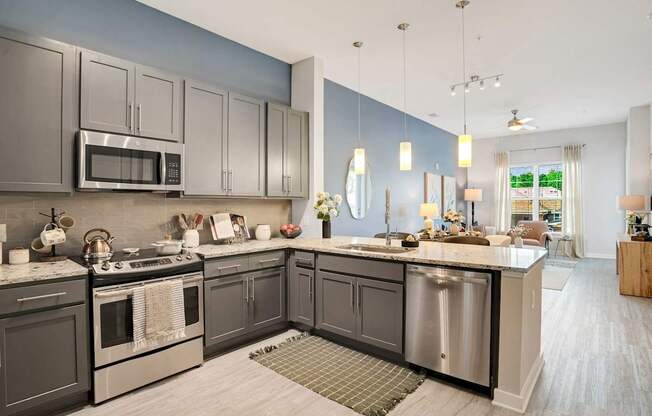 A Kitchen With a Large Island at The Aster Apartments, Cary, NC