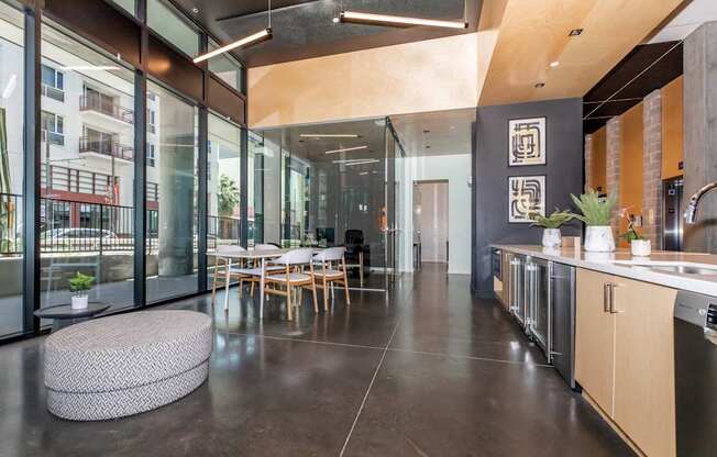 A modern kitchen with a dining table and chairs.