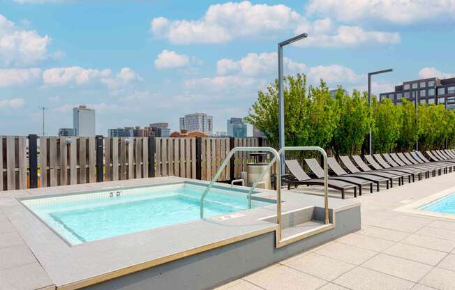 A pool with a view of the city in the background.