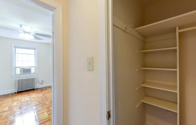 large closet with shelving and view of hallway at  colonnade apartments in washington dc