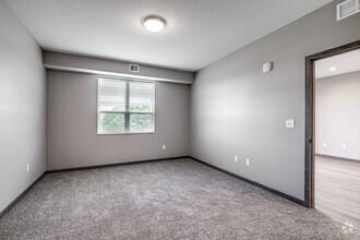 an empty room with a window and a door