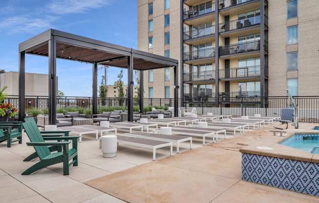 an outdoor lounge area with lounge chairs and umbrellas at the melrose apartments at The Gateway at West Lake Quarter in Minneapolis, MN