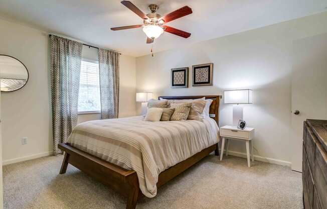a bedroom with carpeted flooring and a ceiling fan