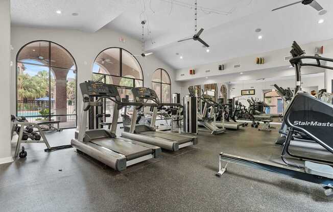 A gym with treadmills, weights, and exercise machines.