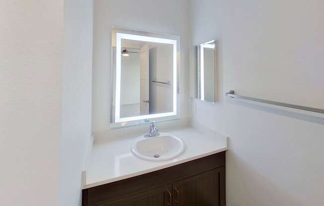 A bathroom with a sink and mirror at Meadowbrooke Apartment Homes in Kentwood, MI 49512