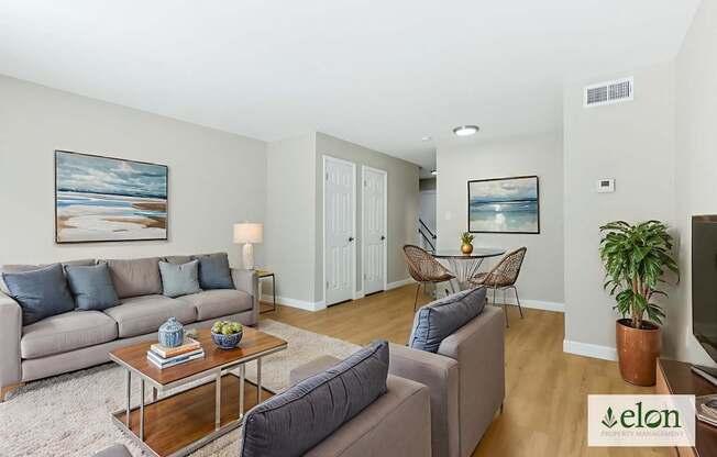 A living room with a grey couch and a coffee table.