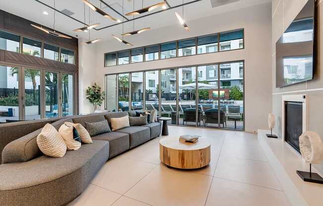 A modern living room with a curved sofa and a coffee table.