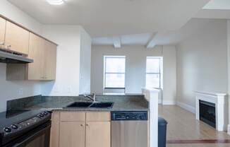 a kitchen with wooden cabinets and a stove and a sink