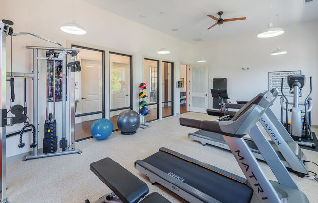 A well-equipped home gym with a variety of exercise equipment.