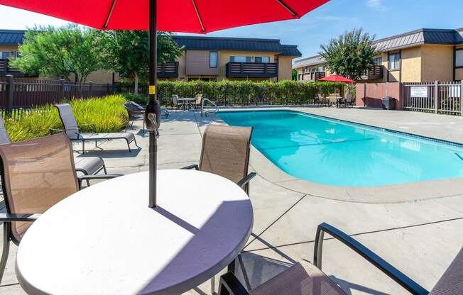 resident pool with lounge seating and umbrellas