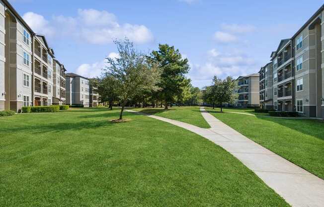 exterior view with walking paths at Park at Magnolia apartments