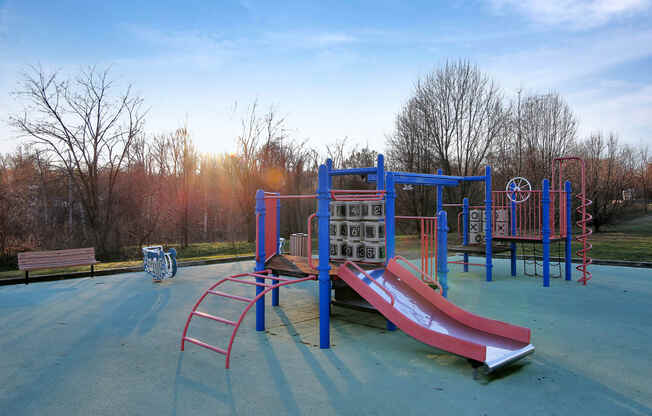 a playground with a slide and other equipment in a park