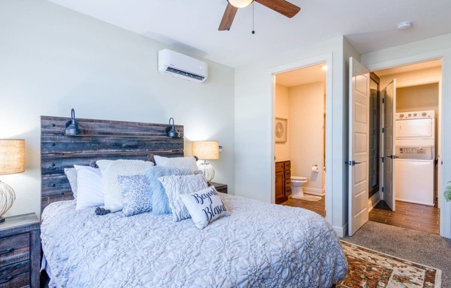 a bedroom with a bed and a ceiling fan