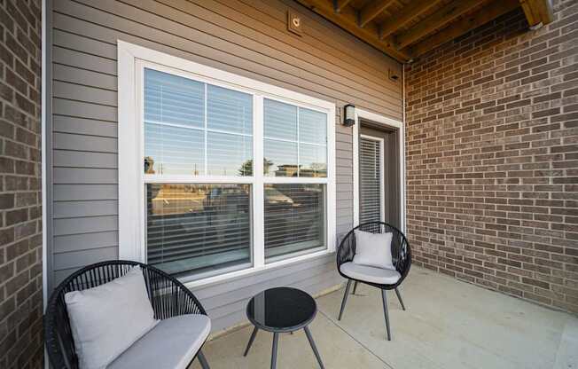 A patio with a chair and a table.