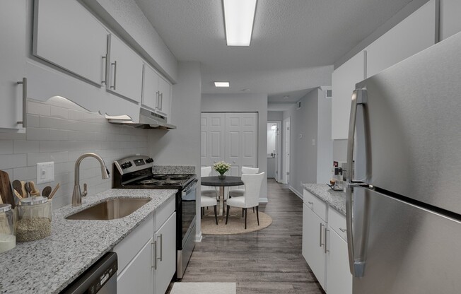Elevate your lifestyle at Icon Downtown Durham. This modern kitchen features sleek stainless steel appliances, elegant countertops, and an inviting dining area perfect for entertaining. Don’t miss out—schedule your tour today!