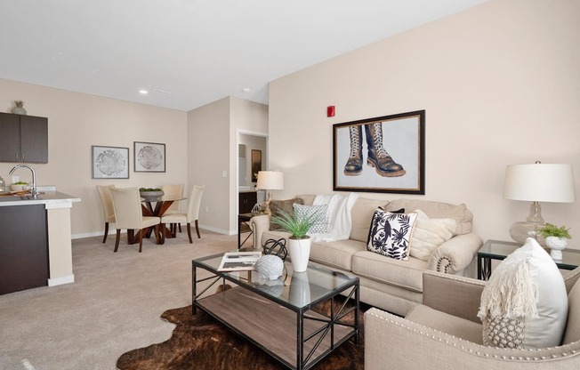 a living room with a couch and a coffee table  at Aventura at Wentzville, Wentzville