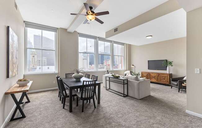 A living room with a dining table and chairs.