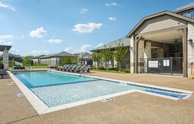 A swimming pool with a building in the background.