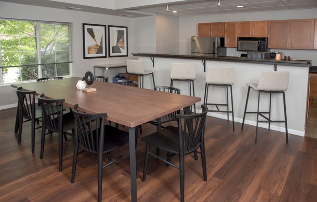 UPI community room with table seating and kitchen at Urban Park I and II Apartments, Minnesota