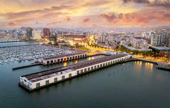 A marina filled with lots of boats at sunset.