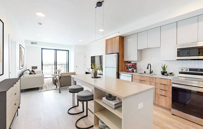 a kitchen with a large island and a living room
