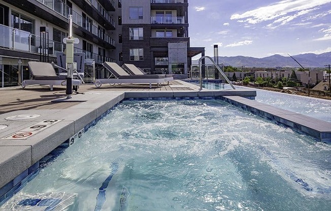 A swimming pool in a resort with a mountain view.