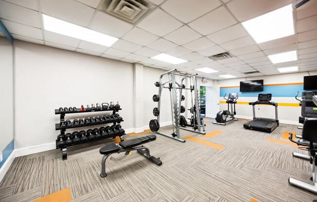 a gym with weights and other exercise equipment at the monarch apartments