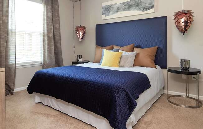 a bedroom with a large bed and a blue headboard