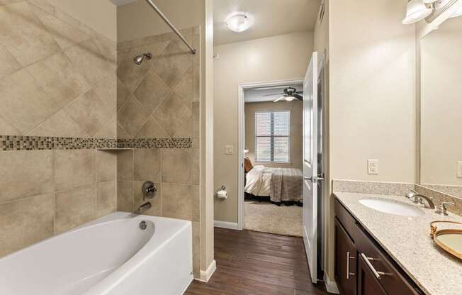 A bathroom with a white tub and a walk-in shower.
