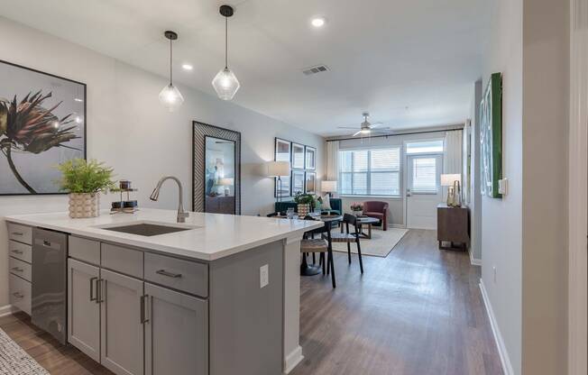 an open kitchen and living room with a dining room table