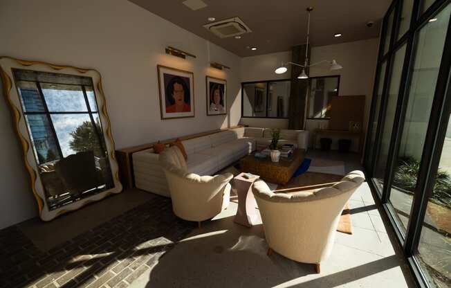 a living room with a couch and chairs and a large window  at The Lady, Columbia, SC, 29201