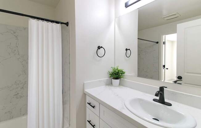 Renovated bathroom with marble counters at Melrose on 91 Apartments in Redmond, WA.