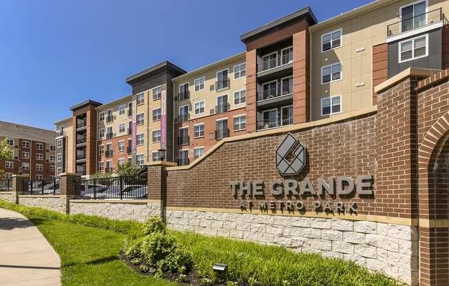 a brick building with the grande metro park sign in front of it