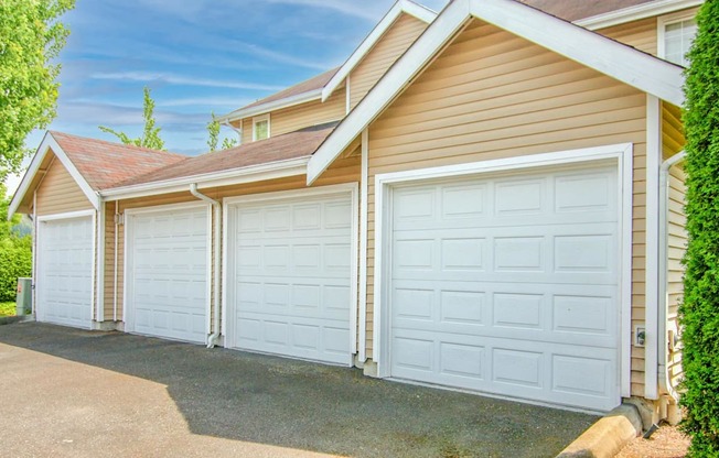 a row of garage doors on the side of a house