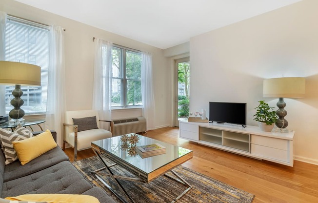 a living room with a couch and a coffee table and a television at Pier Village Apartments, Long Branch