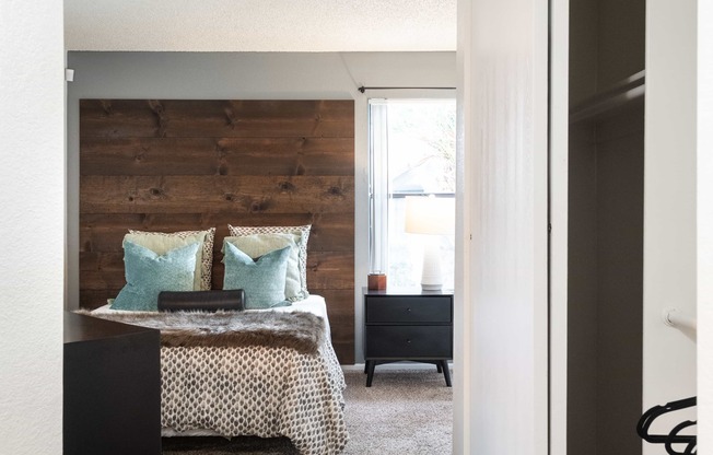 a bedroom with a bed and a wooden accent wall