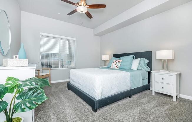 a bedroom with a bed and desk in a room