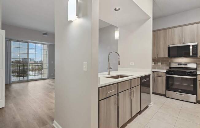 A kitchen with a sink, stove, and oven.