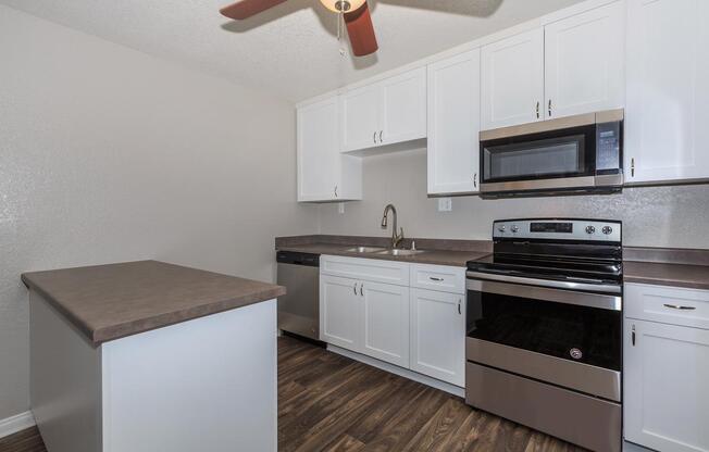 a stove top oven sitting inside of a kitchen