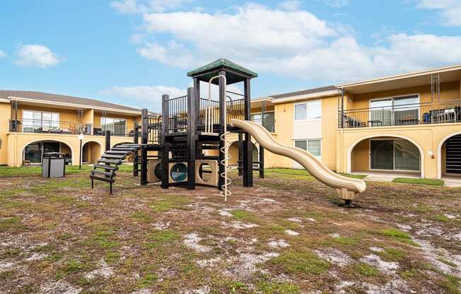 a playground with a slide    and apartments