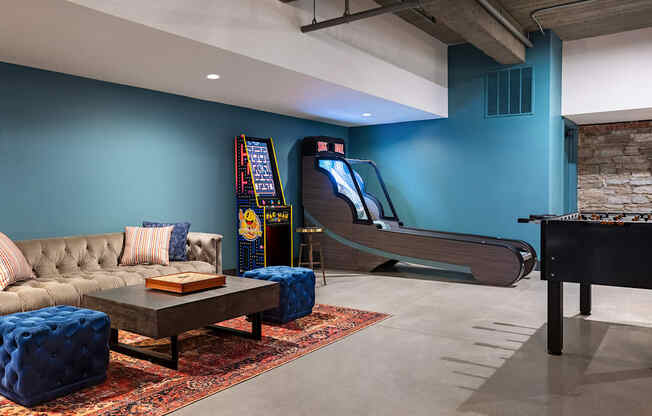 a game room with a piano and a couch and a coffee table