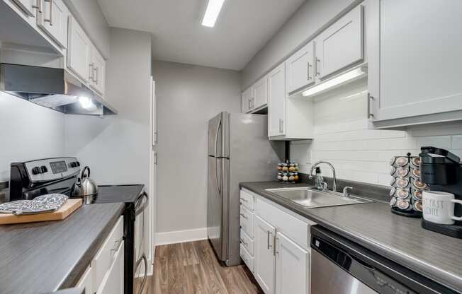 Kitchen With White Cabinetry & Stainless Steel Appliances