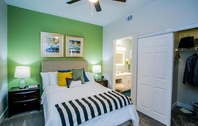 a bedroom with a bed and a ceiling fan