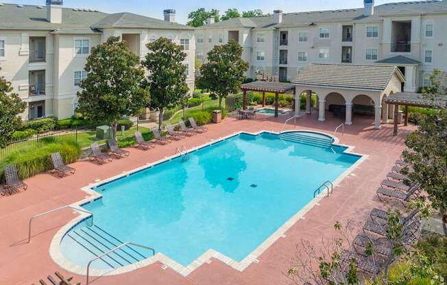 A large swimming pool surrounded by apartment buildings.