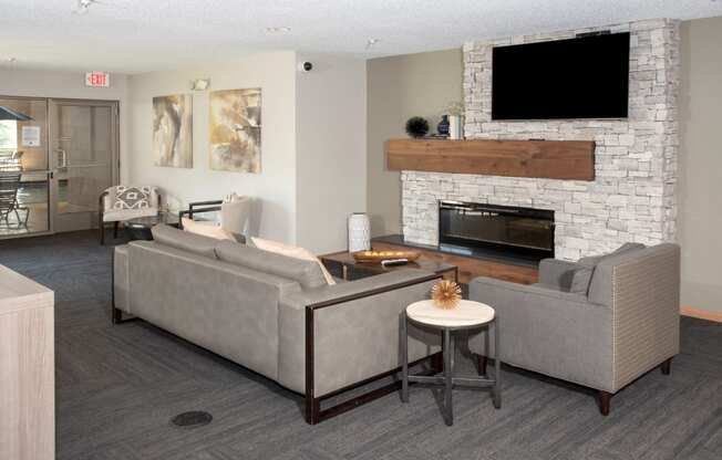 community room with seating, tv and fireplace