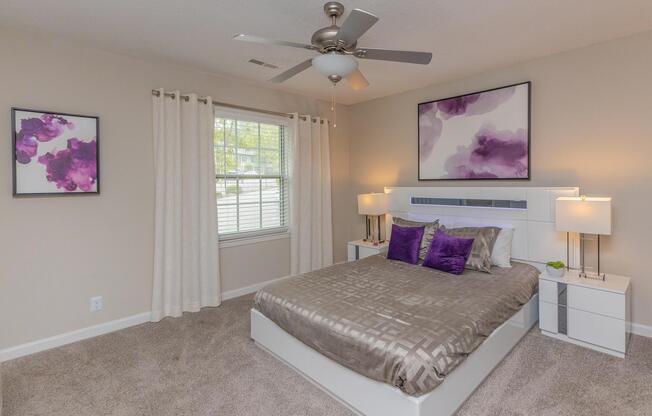 a bedroom with a bed and desk in a room