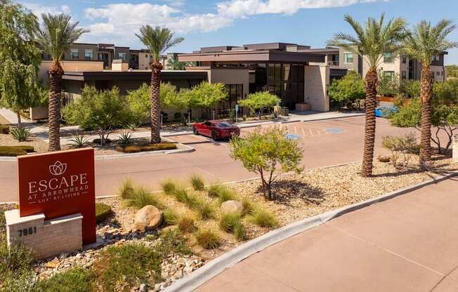 A red car is parked in front of a building with a sign that reads "Escape at Northridge".