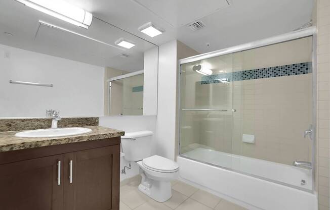 A bathroom with a sink, toilet, and bathtub.